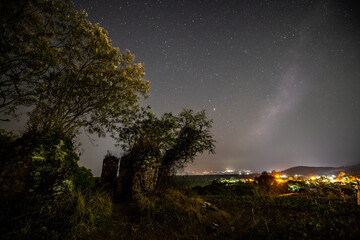 
Night landscape of an old church eaten by the jungle, in the background you can see the amazing night sky, with the Milky Way rising on the horizon and the stars guarding it. 2