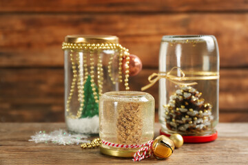 Handmade Christmas snow globes on wooden table