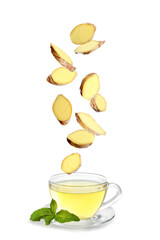 Fresh sliced ginger falling into glass cup of tea on white background