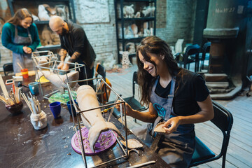 Portrait of young woman enjoying favorite job in workshop.