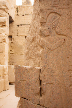 Priest hieroglyph in the wall of ruins in egyptian temple