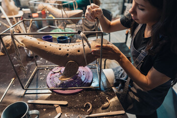 Portrait of young woman enjoying favorite job in workshop.