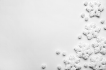 Beautiful snowflakes and decorative balls on white background, flat lay. Space for text