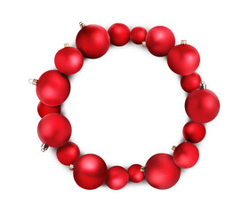 Beautiful festive wreath of red Christmas balls on white background, top view