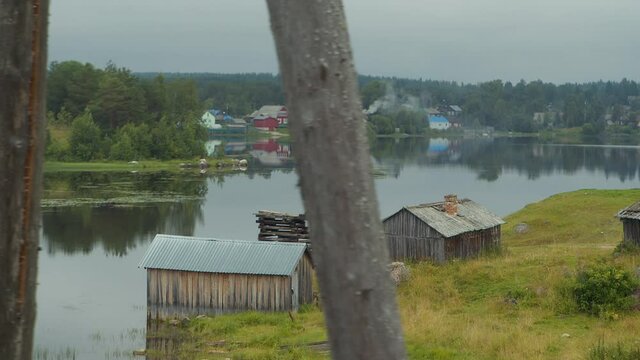 The old rickety wooden house in the water on the shore of a lake in Karelia, Russia. In motion.