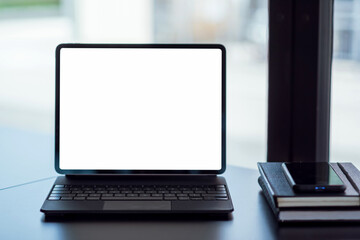 Mock up. blank screen digital tablet with office supplies on black wooden table.