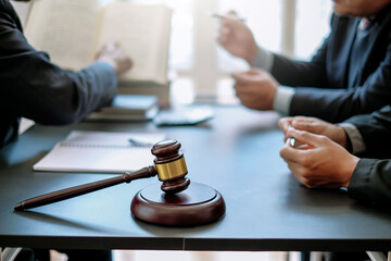 Business lawyer working about legal legislation in courtroom to help their customer.