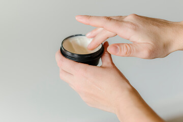 Fototapeta premium A person holding hand moisturizer