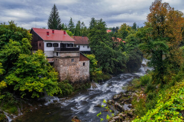 Fototapeta na wymiar Rastoke Village near Slunj in Croatia, old water mills on waterfalls of Korana river. August 2020, long exposure picture.