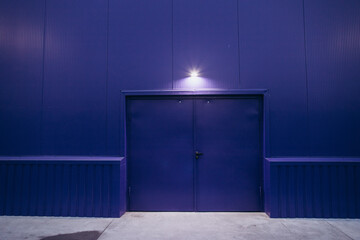 blue door to a blue building with a light bulb on top