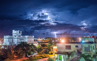 View of lightning ay night from the roof of a tonw in Cuba  - 392992832