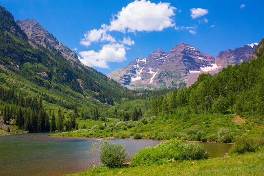 Beautiful, majestic Maroon Bells surrounded by lush greenery near Aspen, Colorado, in summer © Claudia