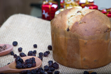Christmas table. making panettone. with chocolate and raisin panettone. rustic table with wood and dark background. copy space