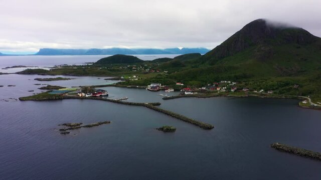 Aerial view of the Sto town at the northern tip of the island of Lang&oslash;ya, in Vesteralen archipelago, cloudy day, in North Norway - tracking, drone shot