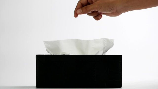 Slow motion woman hand picking white tissue paper from tissue box. Healthcare concept. 