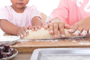 Obraz na płótnie Canvas Close-up hands of children making noodles with mother