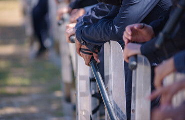 Riot police practice shields and baton
