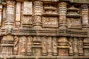 Ancient sandstone carvings on the walls of the ancient sun temple at Konark, India.
