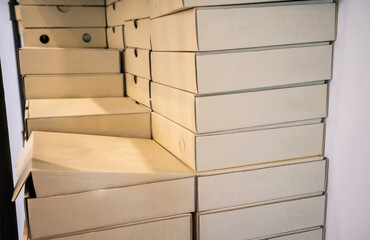 Stack of recycle papaer square boxes on white wall