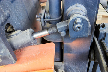 close up of an machine with hydraulic cylinder
