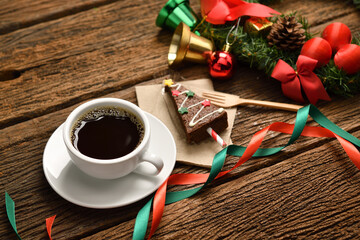 Cup of coffee with Christmas decorations on old wooden table