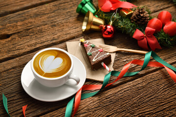 Cup of coffee with Christmas decorations on old wooden table