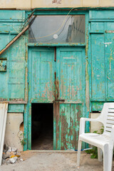 Broken door and exterior of abandoned house