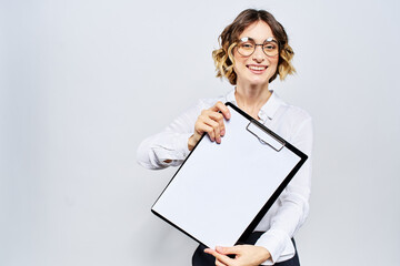 Business woman with a folder of white documents in her hand on a light background And hairstyle glasses model