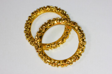 Beautiful Indian style gold bangles/jewelry laying on white background 