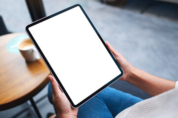Mockup image of a woman holding digital tablet with blank white desktop screen