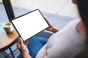 Mockup image of a woman holding digital tablet with blank white desktop screen