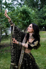 Portrait of a female model in ethnic indian costume with jewellery and traditional makeup.