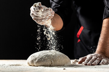 Photo of flour and men hands with flour splash, ball dough on white powder covered table. concept of nature, Italy, food, diet and bio