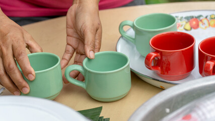 A person cleaning a coffee cup