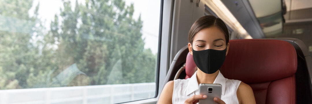 Train passenger Asian business woman using mobile phone during travel commute wearing face mask for corona virus pandemic. Panoramic banner of businesspeople commuting.
