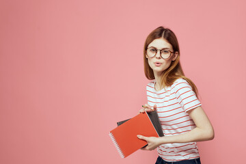 beautiful female student holding books education institute gesturing with hands pink background Copy Space