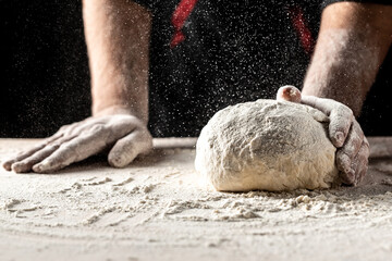Photo of flour and men hands with flour splash. Cooking bread. Kneading the Dough. yeast dough for...