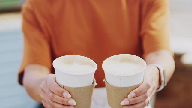 Woman Running Mobile Coffee Shop Holding Takeaway Cups Towards Camera Outdoors Next To Van - Shot In Slow Motion