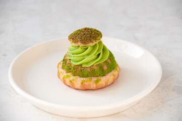 Cake with pistachio cream in a plate on the table