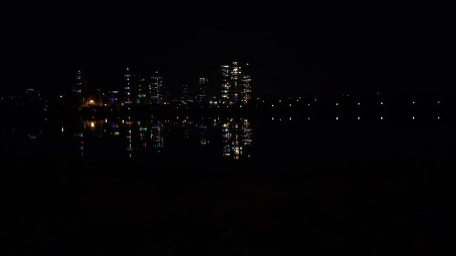 iluminating building reflecting in lake at diwali night in India Mumbai shot 1