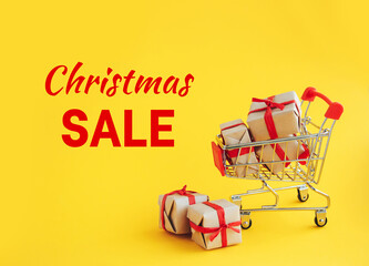 Christmas sale shopping cart with gifts on yellow background. Holiday, seasonal sale concept. - 393019227