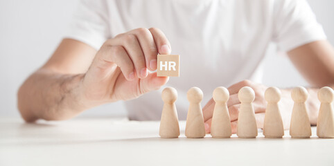 Man holding wooden cube. HR. Human Resources
