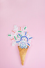 Snowflakes in a waffle Cup on a pink background.