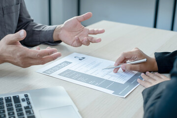 Business people hold a resume and talk to job applicants for job interviews about careers and Her personal history in the company. Recruitment concepts
