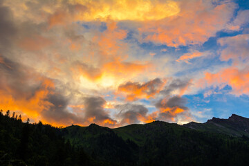 Sun reflected clouds in the sky and silhouette of mountains of Himalaya