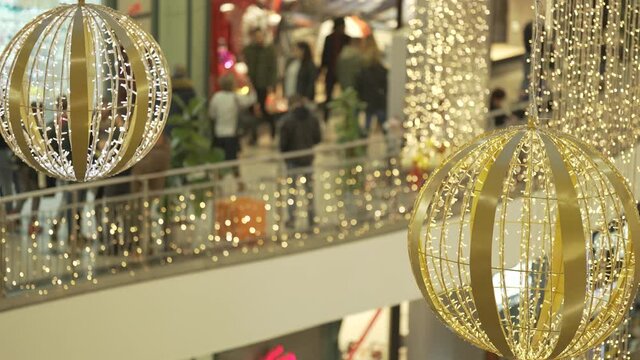 Unrecognizable shopping mall in Christmas lights, many people shoppig stock video.
