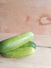 fresh cucumber during the day on a wooden background