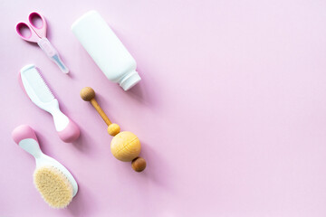 Baby care kit on pink background, top view, copyspace. Concept of children's hygiene. Flat composition with children's accessories, background.