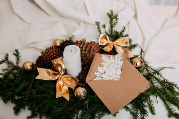 Scandinavian christmas card with white fabric and christmas wreath with white candles inside. Green...