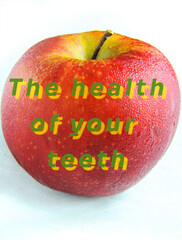 juicy apple in small droplets of water and inscription The health of your teeth          